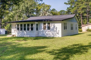 A single-story house with a gabled roof, a front porch, and a small front yard.