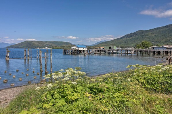 A lakeside pier with buildings and a dock extending into the water. - Oceanfront Craig Apt: Grill, Fishing On-site! (Craig)