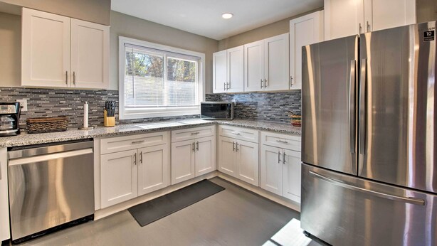 A modern kitchen with white cabinets, stainless steel appliances, and a large refrigerator. - Central Location! ATL Stay 5 Mi to Mercedes-benz (Atlanta)