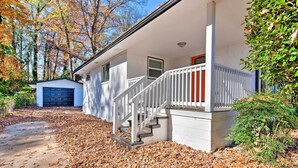 A two-story house with a front porch, a garage, and a driveway covered with fallen leaves. - Central Location! ATL Stay 5 Mi to Mercedes-benz (Atlanta)