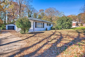 A single-story house with a garage, surrounded by trees and a lawn. - Central Location! ATL Stay 5 Mi to Mercedes-benz (Atlanta)