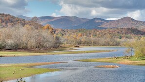 A river meandering through a valley with hills in the background. - Enchanted Forest Cottage w/ Hot Tub! (Hiawassee)