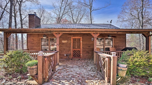 A rustic cabin with a wooden porch, a chimney, and a sign indicating it is a "Sawmill." - 'serenity Cabin' w/ Furnished Deck (Mineral Bluff)