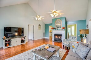 A living room with a fireplace, a television, and a sofa.