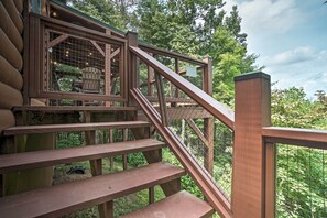 A wooden staircase leading to a deck with a view of the forest. - Yellow Mountain Blairsville Cabin w/ Scenic Deck (Blairsville)