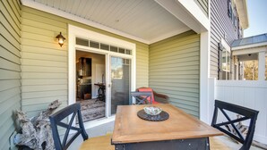 A wooden table with chairs, a decorative bowl, and a rustic chair leg. - Hampton Condo: By Convention Center & Coliseum! (Hampton)