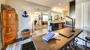 A modern kitchen with a wooden island, a dining area with a table and chairs, and a living room with a sofa and coffee table. - Hampton Condo: By Convention Center & Coliseum! (Hampton)