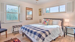 A bedroom with a bed, a ceiling fan, a window, and a nightstand. - Tucson House w/ Private Pool: 5 Mi to Downtown! (Tucson)