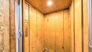 A wooden elevator interior with a sign indicating a cabin. - Riverside Mtn Retreat w/ Hot Tub & Game Room! (Blue Ridge)