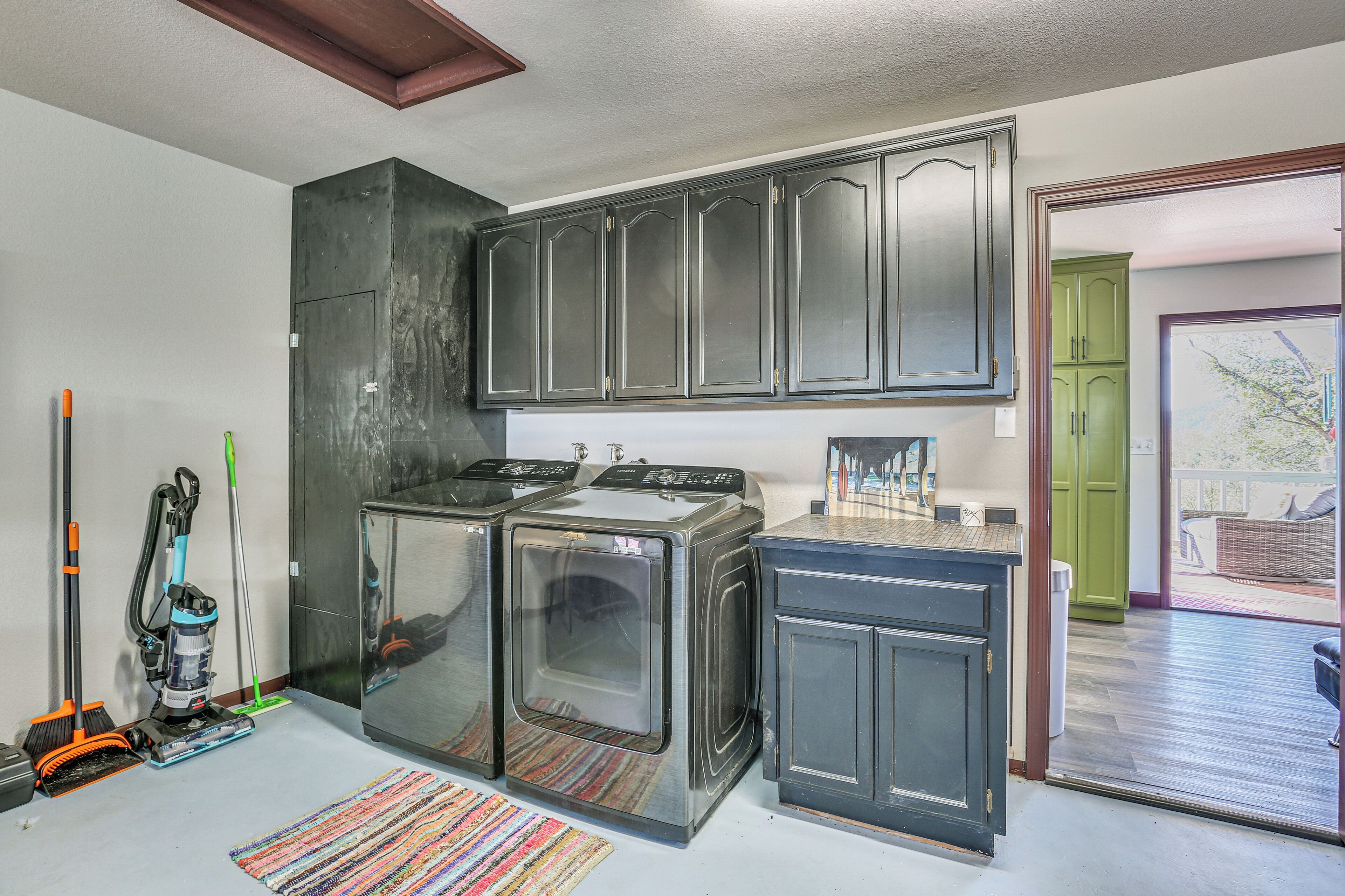 A kitchen with dark cabinets, a built-in oven, and a small countertop.