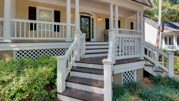 A white porch with a wooden staircase leading to a door. - Stunning Lake Oconee Retreat w/ Pool Access! (Eatonton)