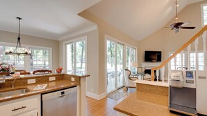 A spacious kitchen with granite countertops, a dishwasher, and a built-in oven. There is a large window providing natural light and a view of the outdoors. - Stunning Lake Oconee Retreat w/ Pool Access! (Eatonton)