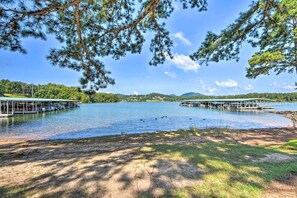 A lakeside view with docked boats, a pier, and a forested area. - Hiawassee Haven on Lake Chatuge w/ Boat Slip! (Hiawassee)