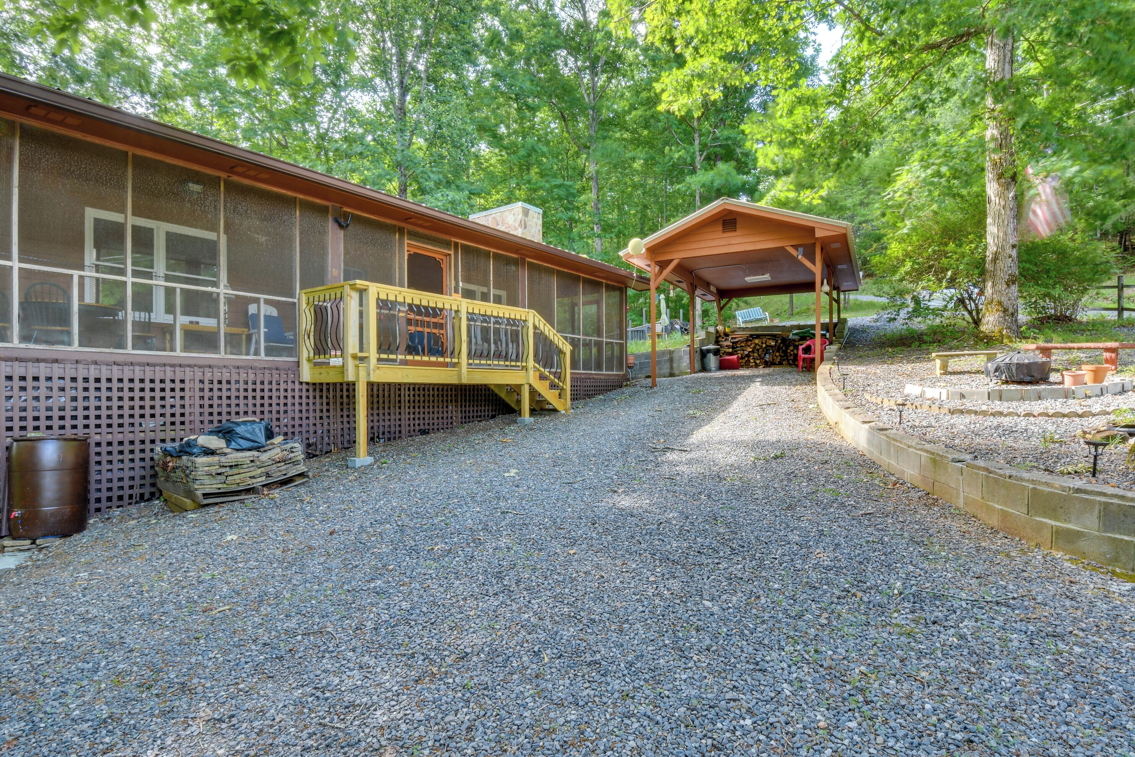 A covered outdoor area with a wooden deck and a covered seating area.