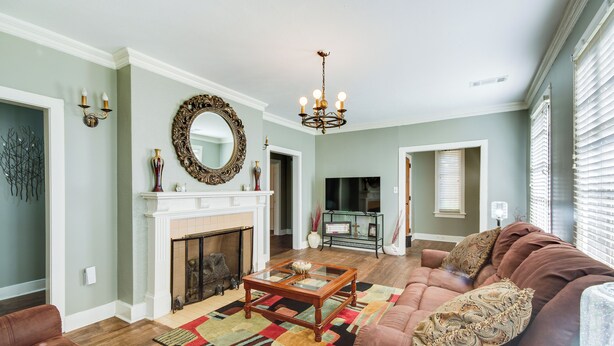A living room with a fireplace, a sofa, a coffee table, and a television. - Cozy Jackson Vacation Rental < 1 Mi to University (Jackson)
