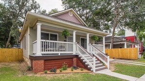 A two-story house with a front porch, a staircase, and a brick foundation. - Savannah Home w/ Patio & Grill ~ 2 Mi to Downtown (Savannah)