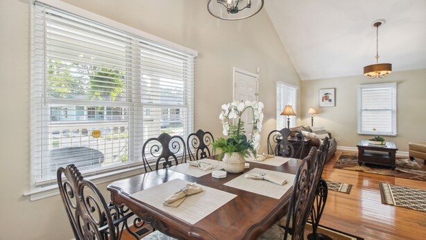 A dining area with a wooden table, chairs, and a chandelier. - Savannah Home w/ Patio & Grill ~ 2 Mi to Downtown (Savannah)