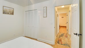A bedroom with a bed, a closet, and a hallway leading to another room. - Spacious Winder Getaway w/ Hot Tub + Game Room! (Winder)