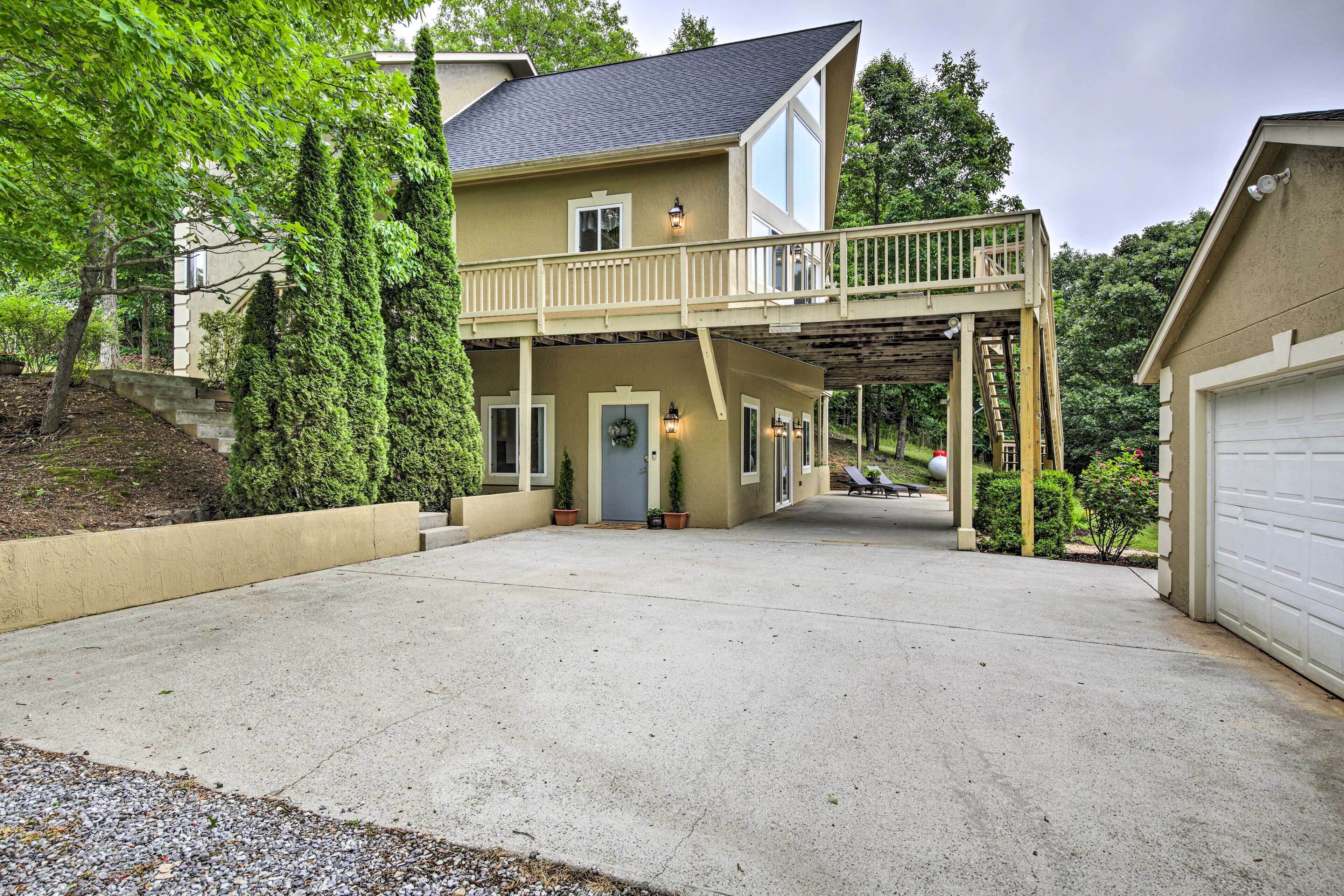 A two-story house with a covered front porch and a garage.
