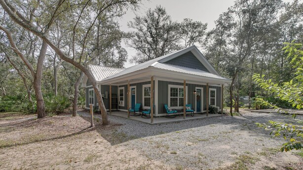 A single-story house with a covered porch and outdoor seating area. - Charming Darien Hideaway w/ Porch, Near Downtown! (Darien)