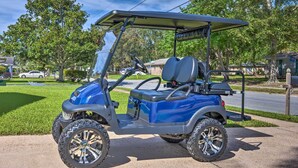 A golf cart parked on a residential driveway. - Ocean Springs Home w/ Bikes < 1 Mile to Beach! (Ocean Springs)
