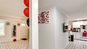 A modern kitchen with white cabinets, a black countertop, and a red towel hanging on the oven. - ~ 13 Mi to Atlanta: Private Stone Mountain Getaway (Stone Mountain)