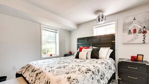 A bedroom with a large bed, a nightstand, a dresser, and a window with blinds. - ~ 13 Mi to Atlanta: Private Stone Mountain Getaway (Stone Mountain)
