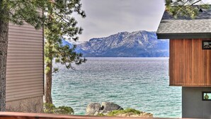 A cabin with a view of a lake and mountains. - Deck & Beach Access: Lake Tahoe Shoreside Retreat! (Zephyr Cove)
