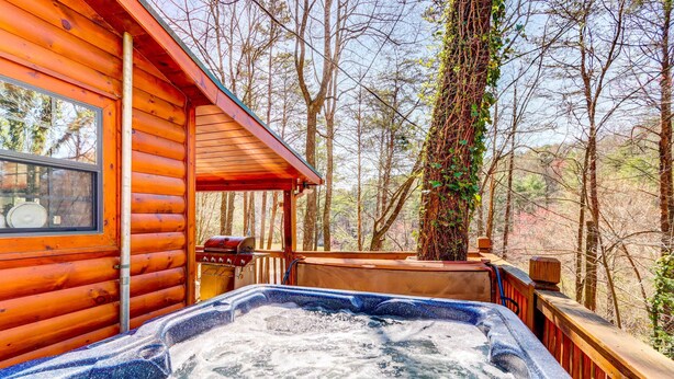 A wooden cabin with a hot tub on a deck surrounded by trees. - Lakefront Blue Ridge Cabin w/ Hot Tub! (Blue Ridge)