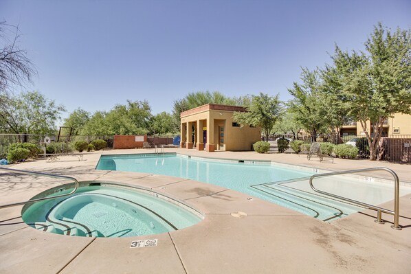 A swimming pool area with a hot tub, a small pavilion, and a building in the background. - Central Tucson Condo w/ Community Pool + Hot Tub! (Tucson)