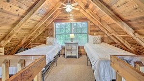 A cozy attic bedroom with two beds, a nightstand, and a ceiling fan. - 'deer Haven' Cabin: 5 Mi to Dtwn Blue Ridge! (Blue Ridge)