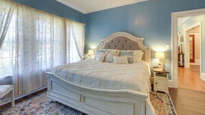 A bedroom with a large bed, a ceiling fan, and a nightstand with a lamp. - 'the Inn on Second' - Jackson Family Home! (Jackson)
