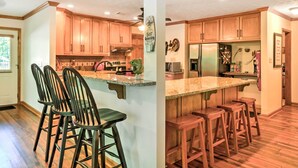 A spacious kitchen with wooden cabinets, a granite countertop, and a stainless steel refrigerator. - Waterfront West Point Lake Cabin w/ Private Dock! (LaGrange)