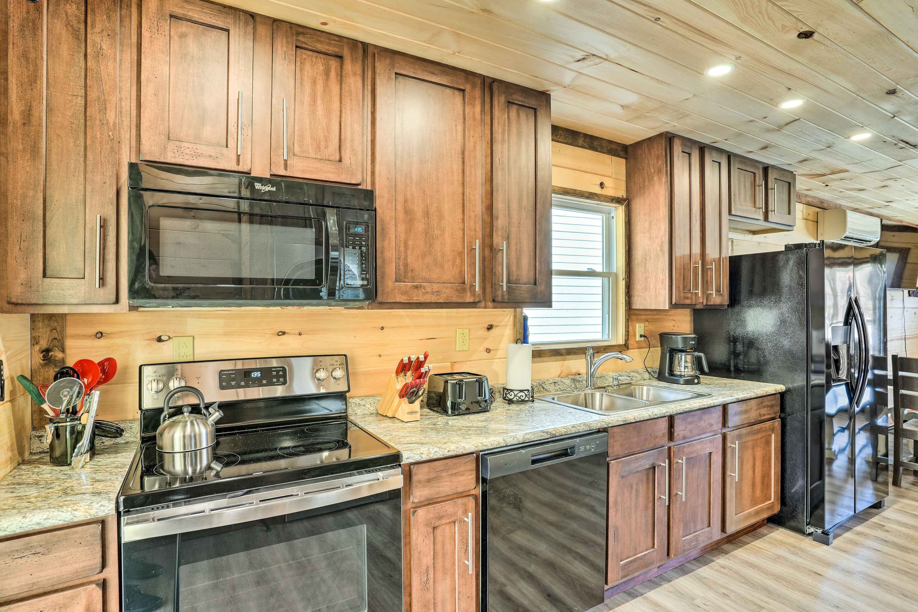 A modern kitchen with wooden cabinets, stainless steel appliances, and granite countertops.