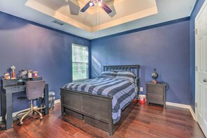 A bedroom with a bed, desk, chair, nightstand, and a ceiling fan. - Snellville Abode < 9 Mi to Stone Mtn Park! (Snellville)