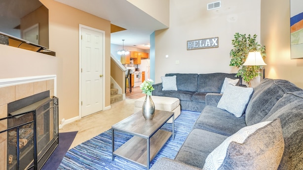 A living room with a fireplace, a sectional sofa, and a coffee table. - Horn Lake Vacation Rental ~ 14 Mi to Memphis! (Horn Lake)