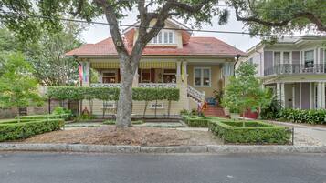 Stunning two-story home with a charming front porch and beautifully manicured garden.