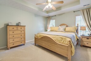 A bedroom with a wooden bed, a dresser, a nightstand, a ceiling fan, and a window with curtains. - Pet-friendly Lagrange Vacation Rental w/ Deck! (LaGrange)