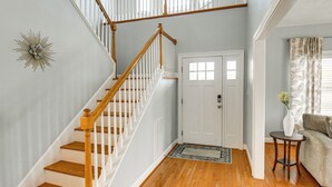 A staircase with wooden steps and white railings leading to a landing. - Inviting Norfolk Family Retreat: 1 Block to Beach! (Norfolk)
