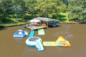 A water park with inflatable water slides and a covered pavilion.