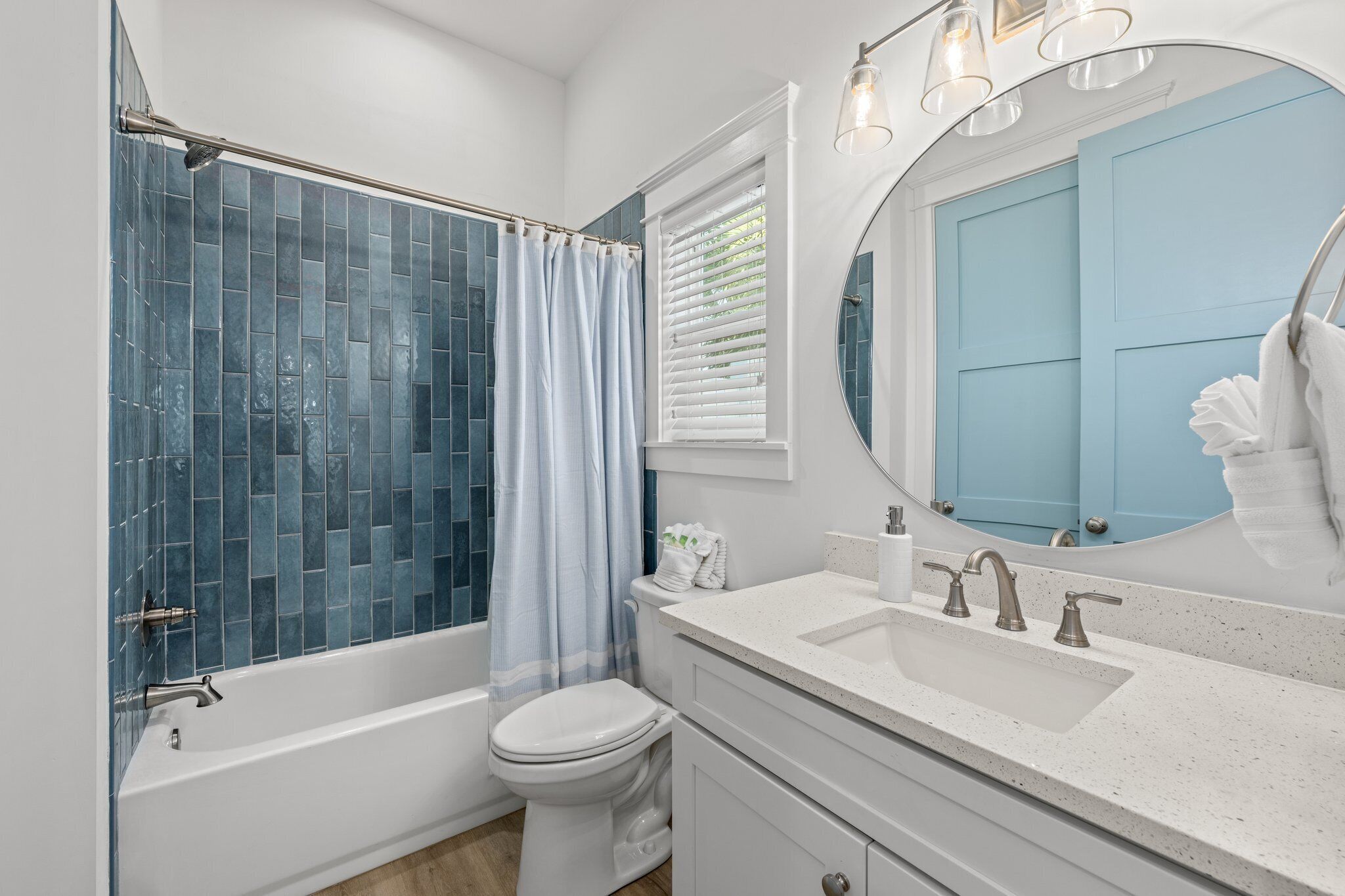 A modern bathroom with a bathtub, toilet, and sink.