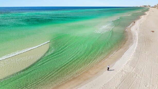 A beach with clear turquoise waters and a sandy shore. - Spectacular 3br 4ba w/ Private Pool, 2 Min Walk to Beach - Sleeps 15! (Panama City Beach)