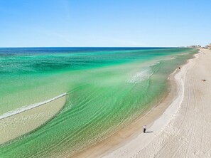 A beach with clear turquoise waters and a sandy shore. - Spectacular 3br 4ba w/ Private Pool, 2 Min Walk to Beach - Sleeps 15! (Panama City Beach)