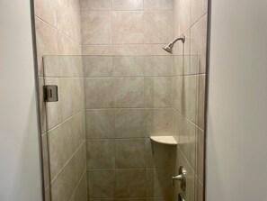 Enjoy a refreshing shower experience with a clear view and convenient storage.