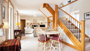A cozy interior with a dining area, a staircase, and a living room. - White House - UKC6895 (Golspie)