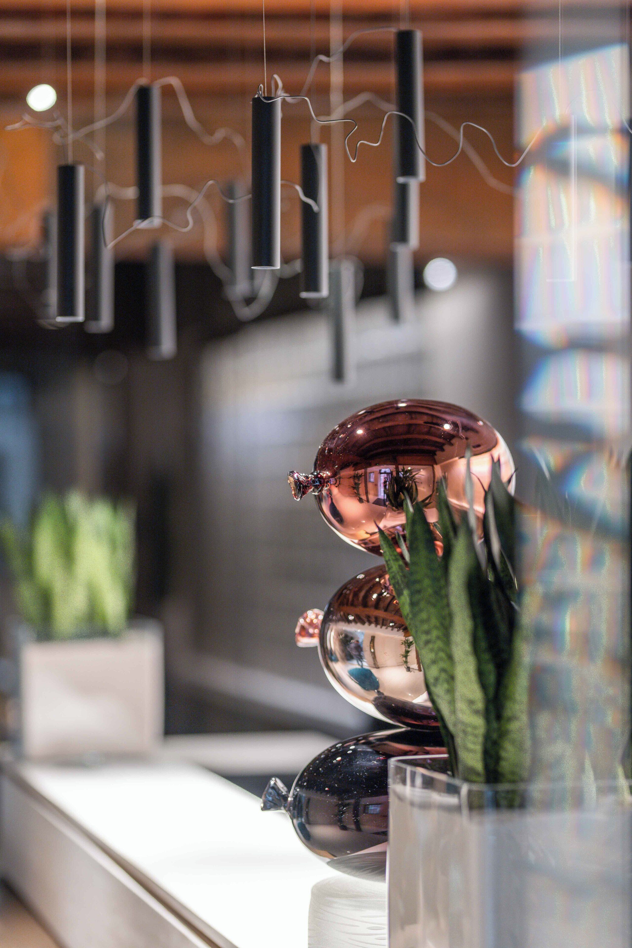 A modern interior with hanging light fixtures and decorative glass spheres.