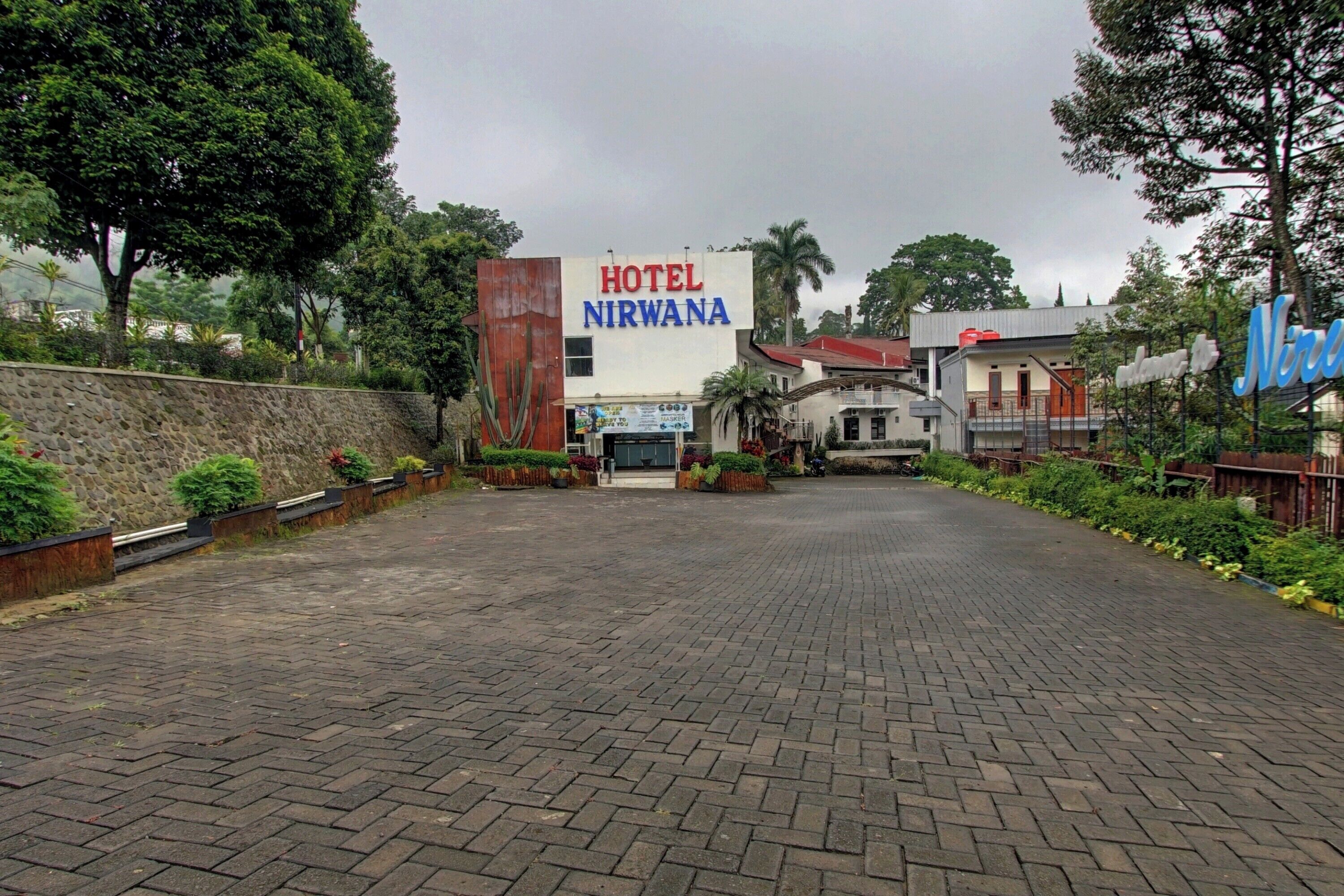 A hotel entrance with a sign reading "HOTEL NIRWANA".