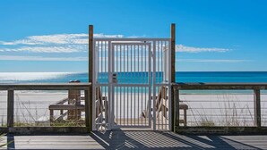A wooden deck with a metal gate leading to a beach. - Studio~Private beach~Restaurant on site~ (Miramar Beach)