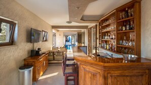 A kitchen with wooden cabinets, a bar area, and a wine rack.