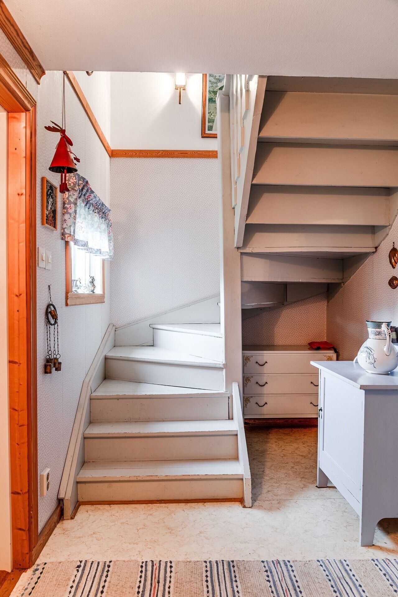 A staircase leading to a loft bedroom with a view of the outdoors.